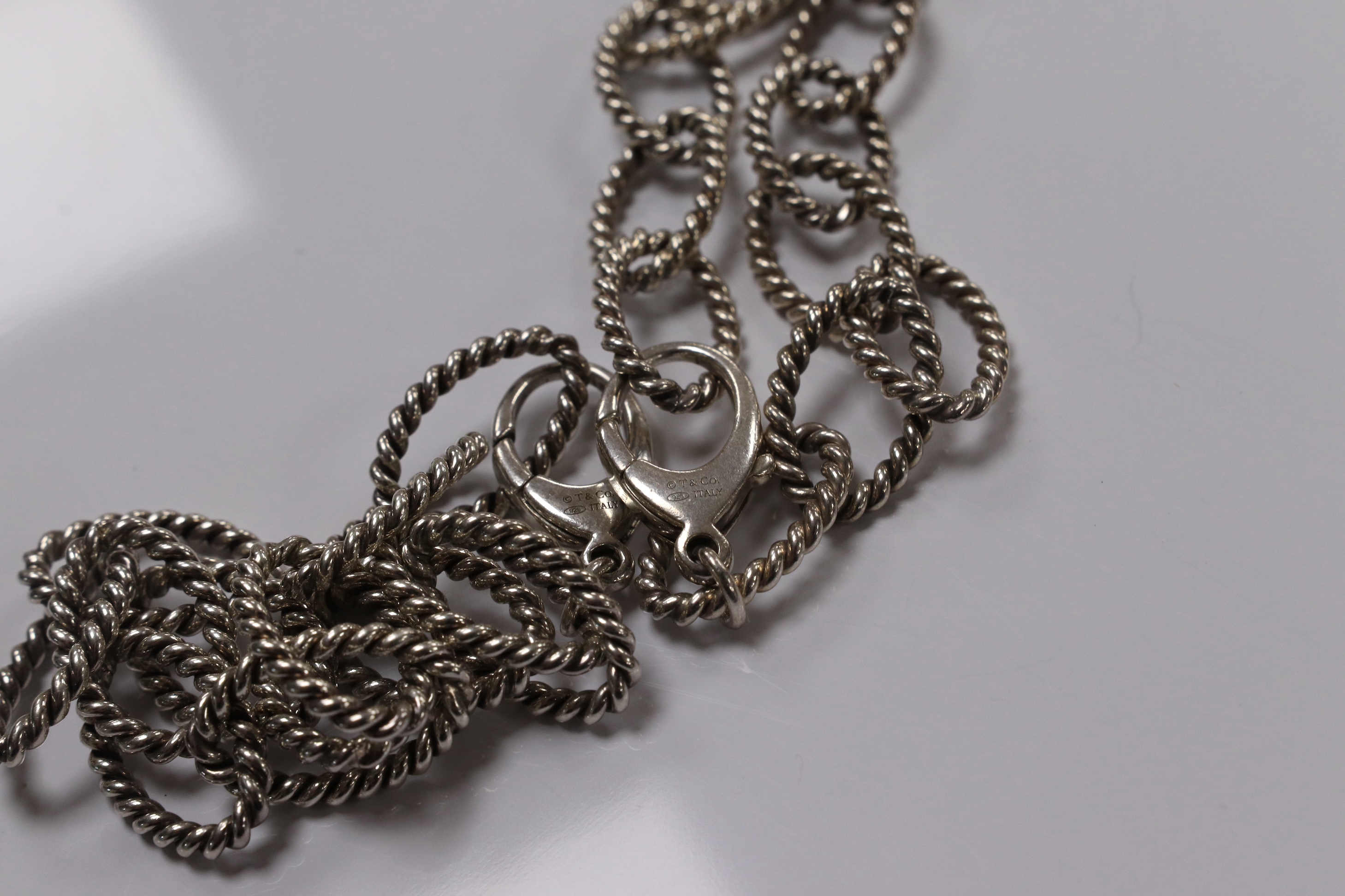 A modern Italian Tiffany & Co 925 suite of jewellery, of rope twist design, comprising a necklace, 42cm, bracelet, 18cm and two rings, size O/P and O. Condition - fair to good